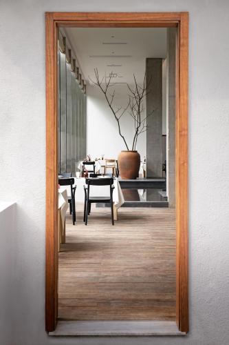 a wooden door leading into a room with a table at 至也 黄果树 in Xinggong