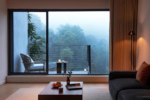 a living room with a large window with a view at 至也 黄果树 in Xinggong
