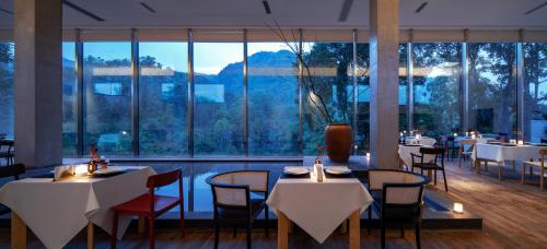 a restaurant with tables and chairs and a large window at 至也 黄果树 in Xinggong