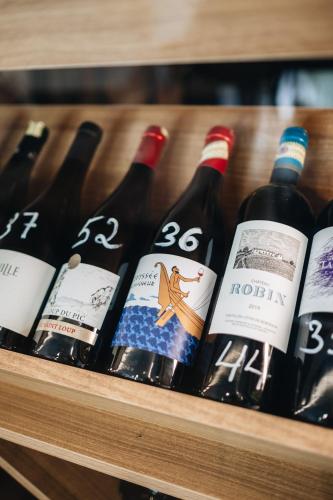 a bunch of bottles of wine on a shelf at Suite Home Boutique Hotel in Phnom Penh