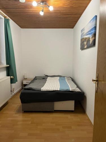 a bedroom with a bed in a room with a ceiling at Ferienwohnung Wittmoldt bei Plön in Wittmoldt