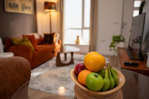 a bowl of fruit on a table in a living room at Coorie Voe in Stromness