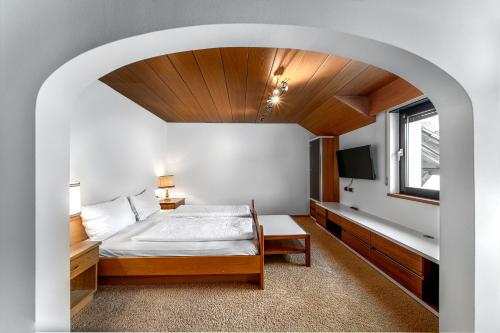 a bedroom with a bed and a tv in a room at Villa Pana in Santa Cristina Gherdëina