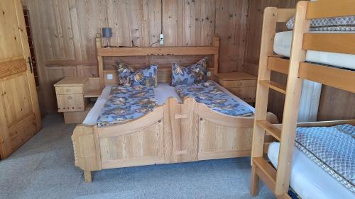 a bedroom with two bunk beds in a cabin at Ferienwohnung Berktold in Bizau