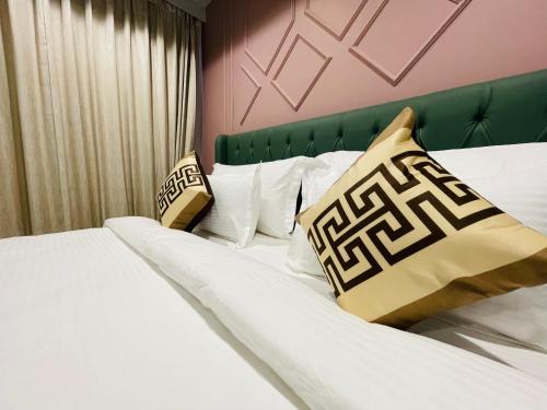 a hotel room with two beds with pillows at Krishna Resort Pushkar in Pushkar