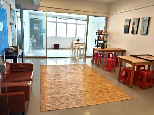 a living room with a rug on the floor at Sunset Homestay - Backpacker Hostel Self Checkin in Kuching