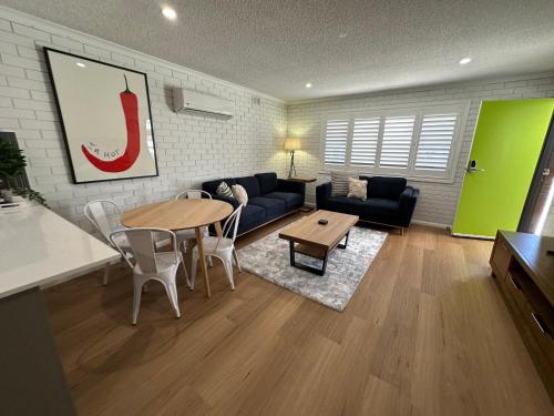 a living room with a couch and a table at Central Cullen Wagga Apartments in Wagga Wagga