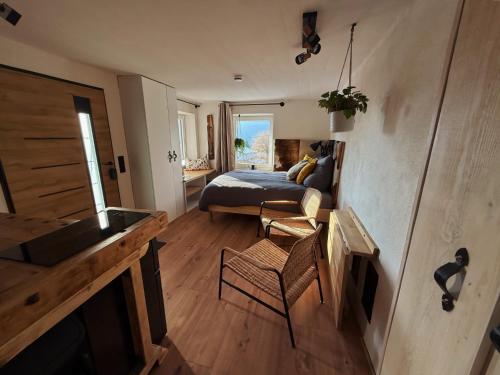 a bedroom with a bed and a living room at Haus am Berch in Weissenstein