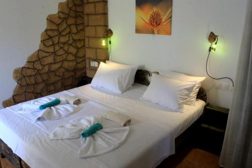 a bedroom with a bed with towels on it at Village Villa Marika Drapanias in Drapaniás