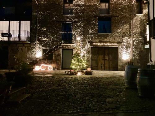 a christmas tree in the courtyard of a building at night at Antica Sosta dei Viandanti in Cadenazzo