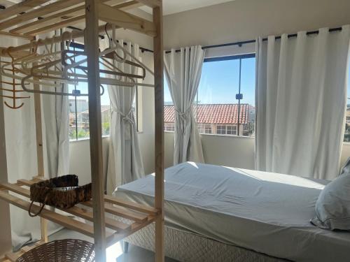 a bedroom with a bunk bed and a window at Villa Darius in Cabo Frio