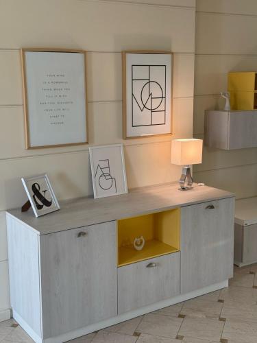 a desk with a lamp and some pictures on it at Casa degli Angeli in Casalmoro