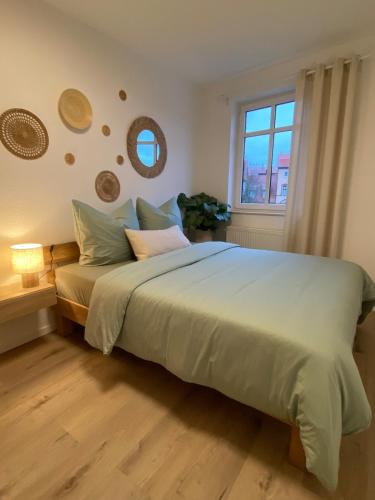 a bedroom with a large bed with a window at Cosy-Chic Apartment in Eisenach