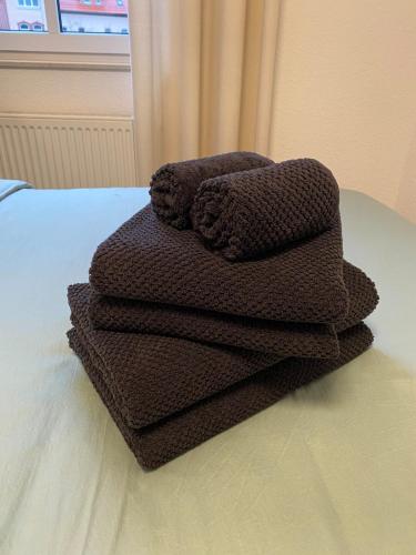 a pile of brown towels sitting on a table at Cosy-Chic Apartment in Eisenach