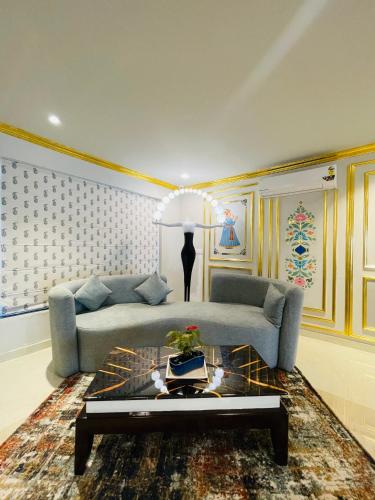 a living room with a couch and a table at Krishna Resort Pushkar in Pushkar