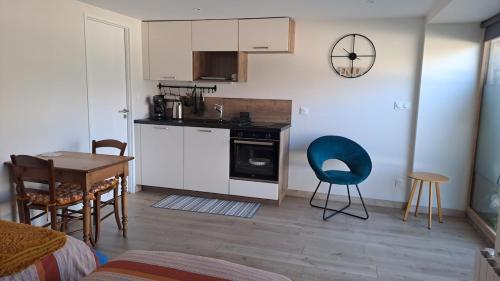 une cuisine et une salle à manger avec une table et des chaises dans l'établissement Studio neuf 25m2 - 2 personnes, à Pélussin