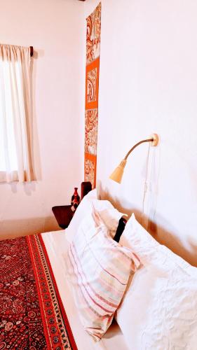 a bedroom with a bed with a lamp on it at Pousada Casa da Edinha in Ilha de Boipeba