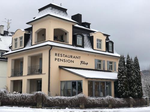 a building with a sign for areskritkrit passion play at Pension a restaurace Filip II in Mariánské Lázně