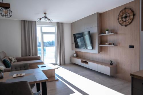 a living room with a couch and a tv at Apartmán DANIEL in Spišská Nová Ves