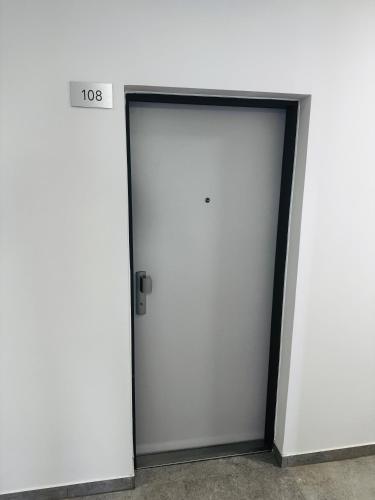a pair of white doors in a building at Apartmán DANIEL in Spišská Nová Ves