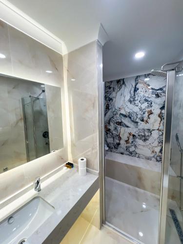 a bathroom with a shower and a bath tub at Tophane Mansion Karakoy in Istanbul