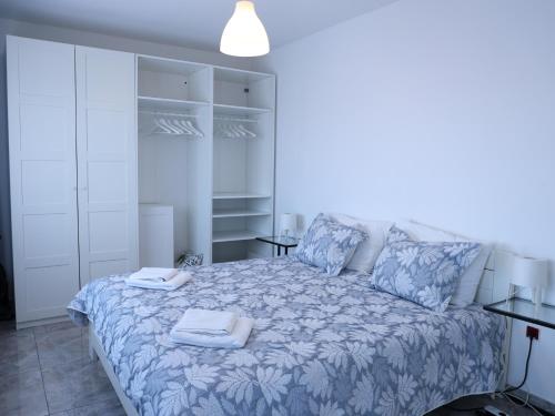 a bedroom with a bed with towels on it at Golden Gate 21 in Ruma