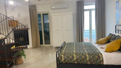 a bedroom with a bed and a staircase in it at Casa Cibella Authentic Charme Apartments in Agrigento