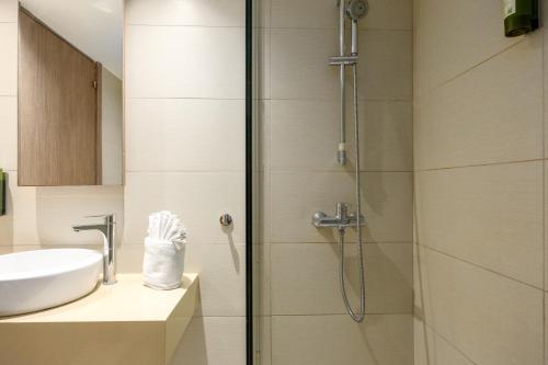 a bathroom with a shower and a sink at Melpo Antia Hotel & Suites in Ayia Napa