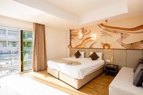 a hotel room with a bed and a balcony at Melpo Antia Hotel & Suites in Ayia Napa
