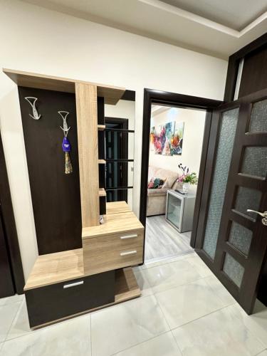 a living room with a dresser and a door at Apartment in Varna City