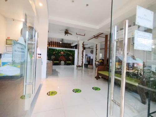 a room with a glass door with signs on the floor at Sulit Budget Hotel VMapa in Manila