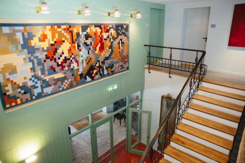 a staircase with a large painting on the wall at Hotel Rural Misarela in Geres