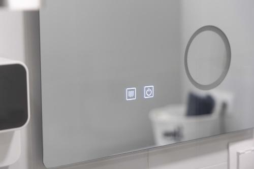 a bathroom with a mirror and a sink and a counter at Astradeni Suite in Nea Potidaea