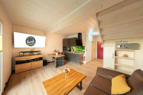 a living room with a couch and a table at Aktiv-Urlaub-Burak Marktleuthen im Fichtelgebirge in Marktleuthen