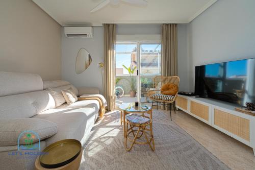 a living room with a couch and a tv at Beach & City Center Apartment Campello in El Campello