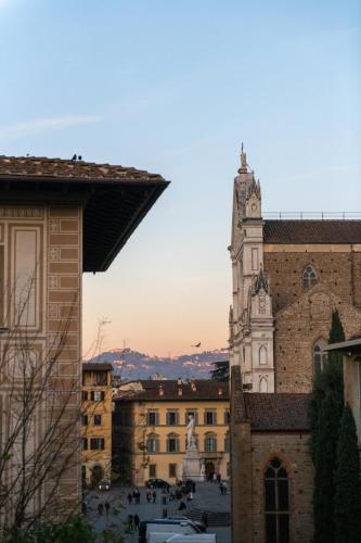 a building with a clock tower in a city at Palazzo Doni by Florence Art Apartments in Florence