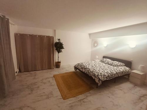 une chambre avec un lit et une plante en pot dans l'établissement Superbe appartement T2 de 95 m, à Nice