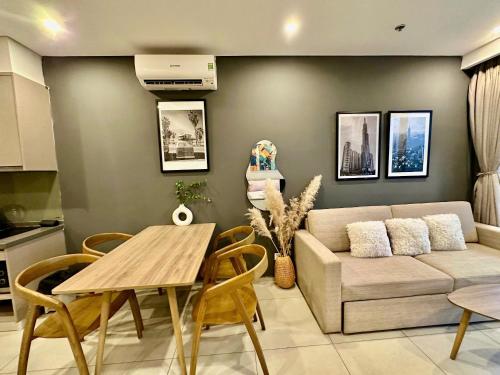 a living room with a couch and a table at The Song Boutique Apartment in Vung Tau