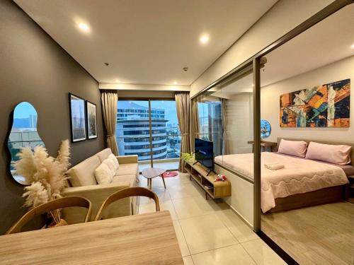 a bedroom with a bed and a living room at The Song Boutique Apartment in Vung Tau