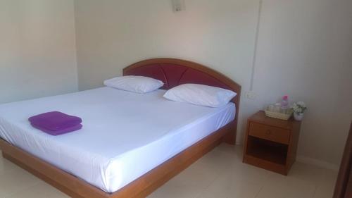 a small bedroom with a bed and a night stand at Krabi Hotel Agency in Krabi town