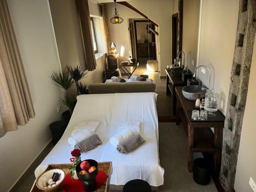 a living room with a bed and a sink at Kotnik Superior Boutique Hotel in Kranjska Gora
