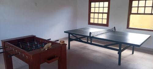a room with a ping pong table and a bed at Residence Geriba in Búzios