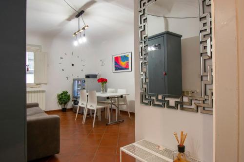 a living room with a table and a mirror at Il Vagello B&B in Florence