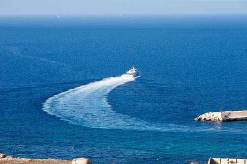 a boat in the middle of the ocean at Il Borgo Del Principino in Favignana