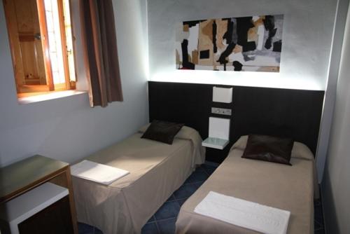 a room with two beds in a room at Hostal Plaza Ruiz in Ceuta