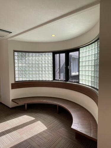 an empty room with a large window and a staircase at 大同ガーデンホテル京都 in Kyoto