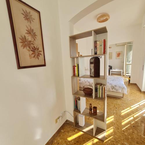 a room with a book shelf and a bed at L' attichetto in Rome