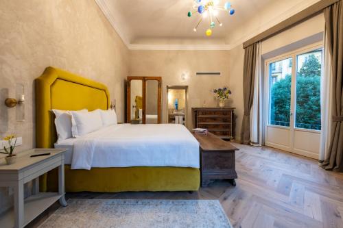 a bedroom with a large bed and a desk at Palazzo Doni by Florence Art Apartments in Florence