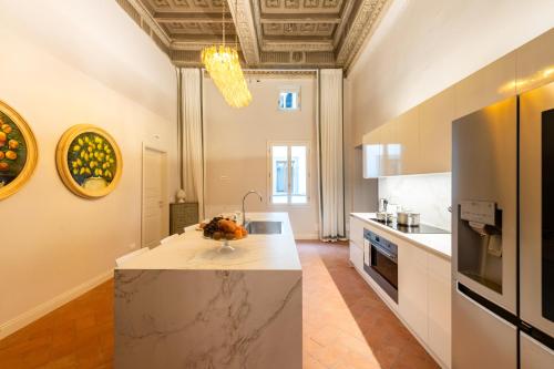 a kitchen with a island in the middle of a room at Palazzo Doni by Florence Art Apartments in Florence