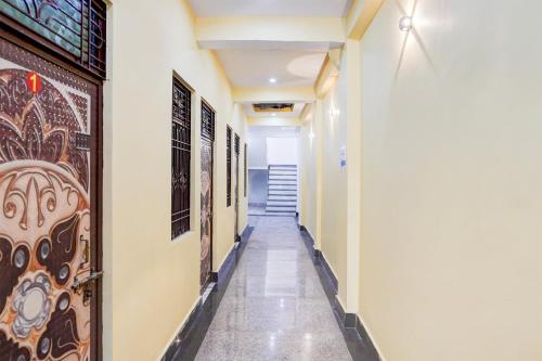 a hallway of a building with paintings on the wall at Pradhan Hotel in Prayagraj